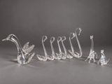 a group of five glass birds sitting on top of each other