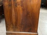 a wooden cabinet that is sitting on a tile floor