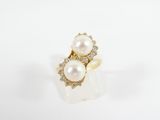 an image of a pearl and diamond ring on a white background
