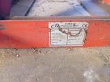 a red box with a sign on it sitting on the ground