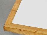 a close up of a wooden table with a white paper on it