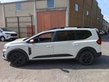a white car parked in front of a building