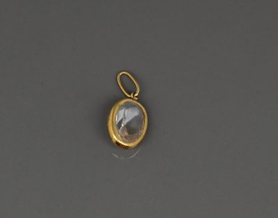 a gold plated pendant with a faceted quartz stone