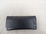 a close up of a black leather case on a white surface