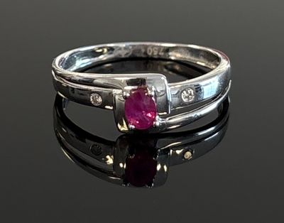an image of a ruby and diamond ring on a black surface