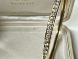an image of a yellow gold ring with diamonds in a box