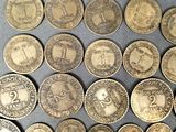 some of the coins have been placed on a table for display