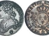 a silver coin with an image of a man in a crown on it