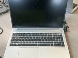 a laptop computer sitting on a desk with a lot of wires