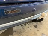 a close up of a blue car with a sticker on it ' s bumper
