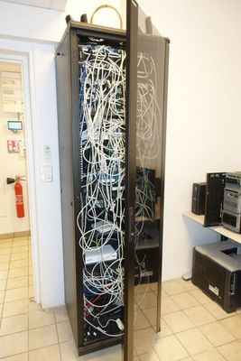 an image of a server in a room with a lot of wires in it