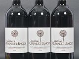 three bottles of red wine sitting on top of a table