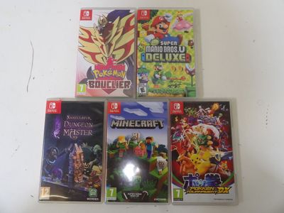 several nintendo wii games sitting on top of a white table