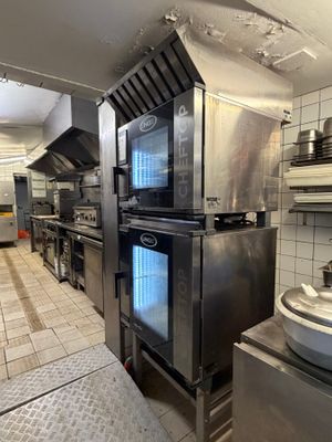 a large kitchen with a lot of stainless steel appliances