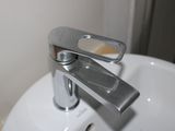 a white sink with a chrome faucet in it