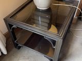 a glass table with a vase on top of it
