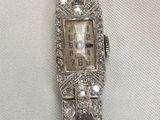 a watch that is sitting on a white cloth
