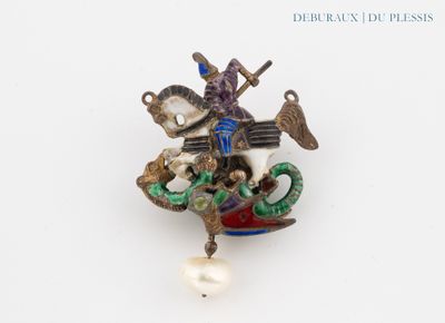 a brooch of a man riding a horse with a pearl bead