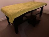 a bed with a yellow blanket on it in a room