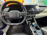 the interior of a car with a steering wheel and dashboard controls