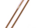a close up of two gold chains on a white background