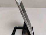 a cell phone that is sitting on top of a stand