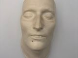 a sculpture of a man ' s face on a wall