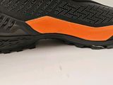 a close up view of a pair of black and orange shoes