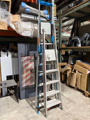 a ladder that is leaning against a wall in a warehouse