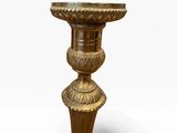 an image of a gold vase on a pedestal on a white background