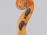 a close up of the back of a violin with a fiddle in the foreground