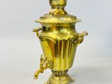 a gold vase that is sitting on a table