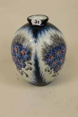 a blue and white vase sitting on a table