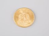 an image of a gold coin sitting on top of a white surface