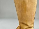 un gros plan sur une paire de bottes posées sur une surface blanche