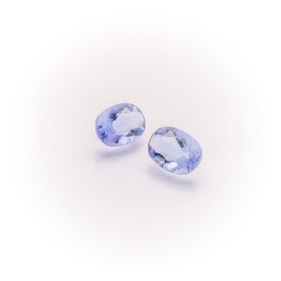 a pair of tanzanite gems on a white background