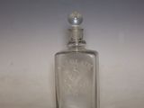a small glass bottle with a silver lid