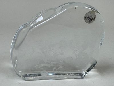 a glass heart shaped object on a white surface