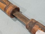two old wooden pipes on display on a table