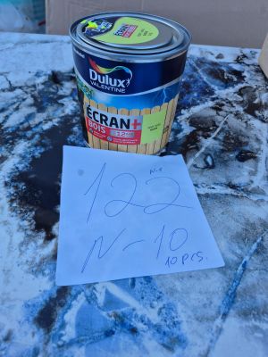 un pot de peinture et une feuille de papier posés sur une table