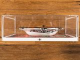 a small bowl in a clear box on a table
