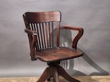 a wooden chair that is sitting on a wooden floor