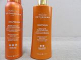 two bottles of tanning lotion sitting next to each other on a table