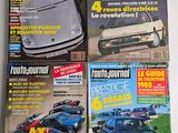 four magazines of different cars on display on a table