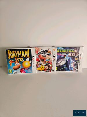 three nintendo wii games sitting on top of a white table