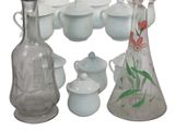 a lot of glass vases and cups on the table