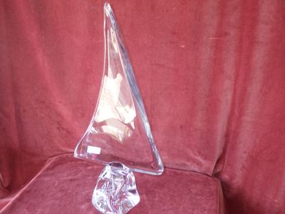 a clear triangle shaped object sitting on a red cloth