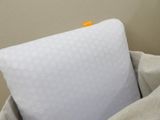 a pillow that is sitting in a bag on the bed