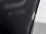 a close up of a black chair with a hole in the back