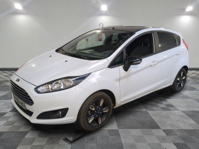 the white ford fiesta is parked in the garage